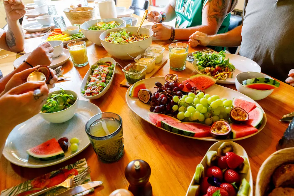 A shared table of fresh salads, fruit and juices during the retreat