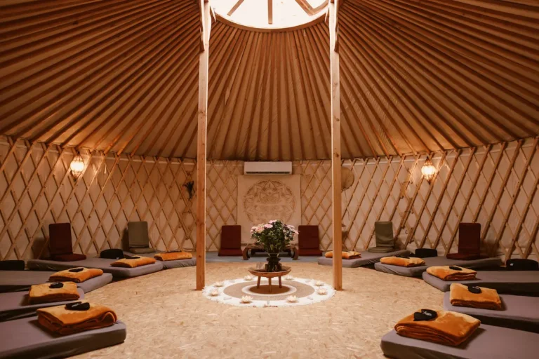 Interior of the ceremony yurt with mats, blankets and a central altar